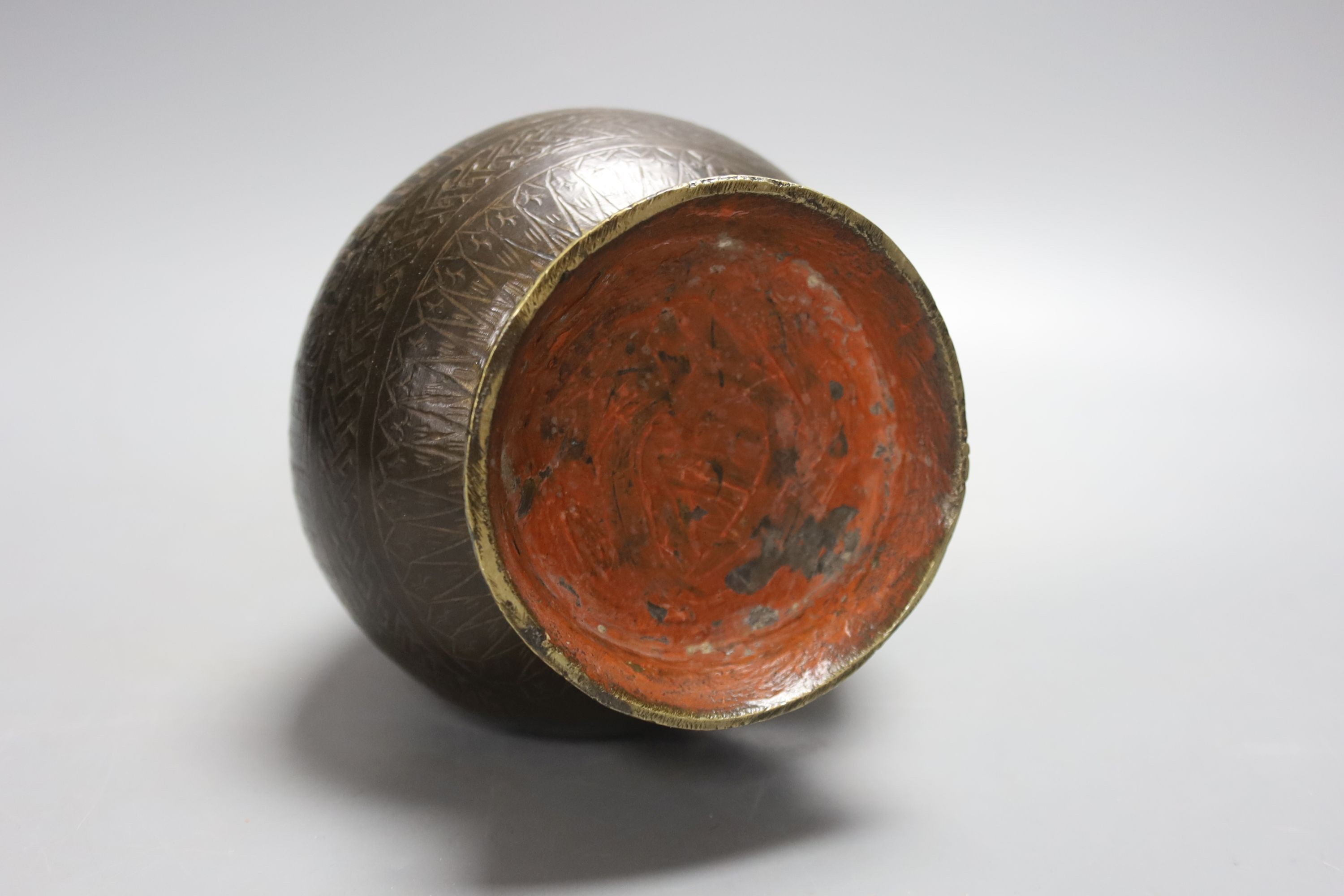 A Middle Eastern Islamic bronze vase, 28 cms high.